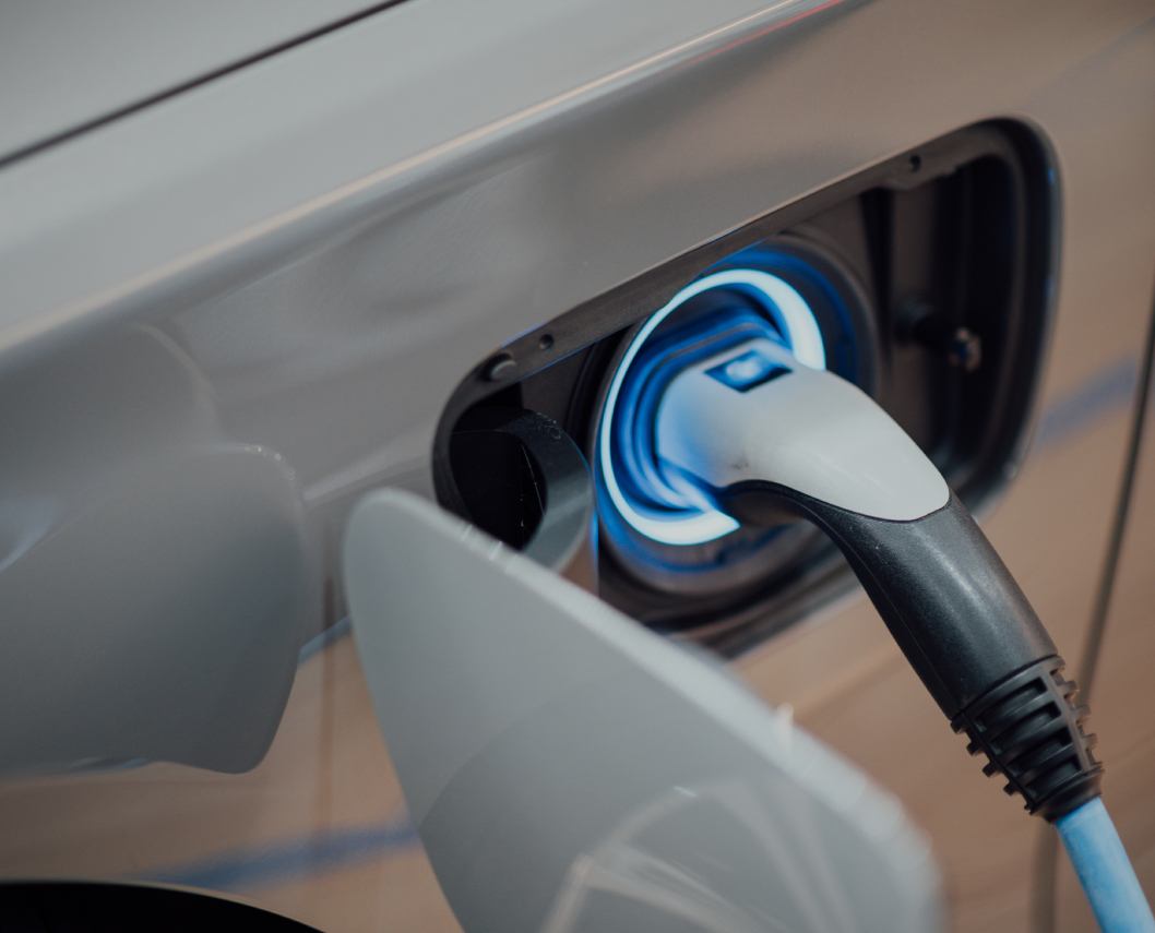 Close-up of an electric car being charged at a charging station